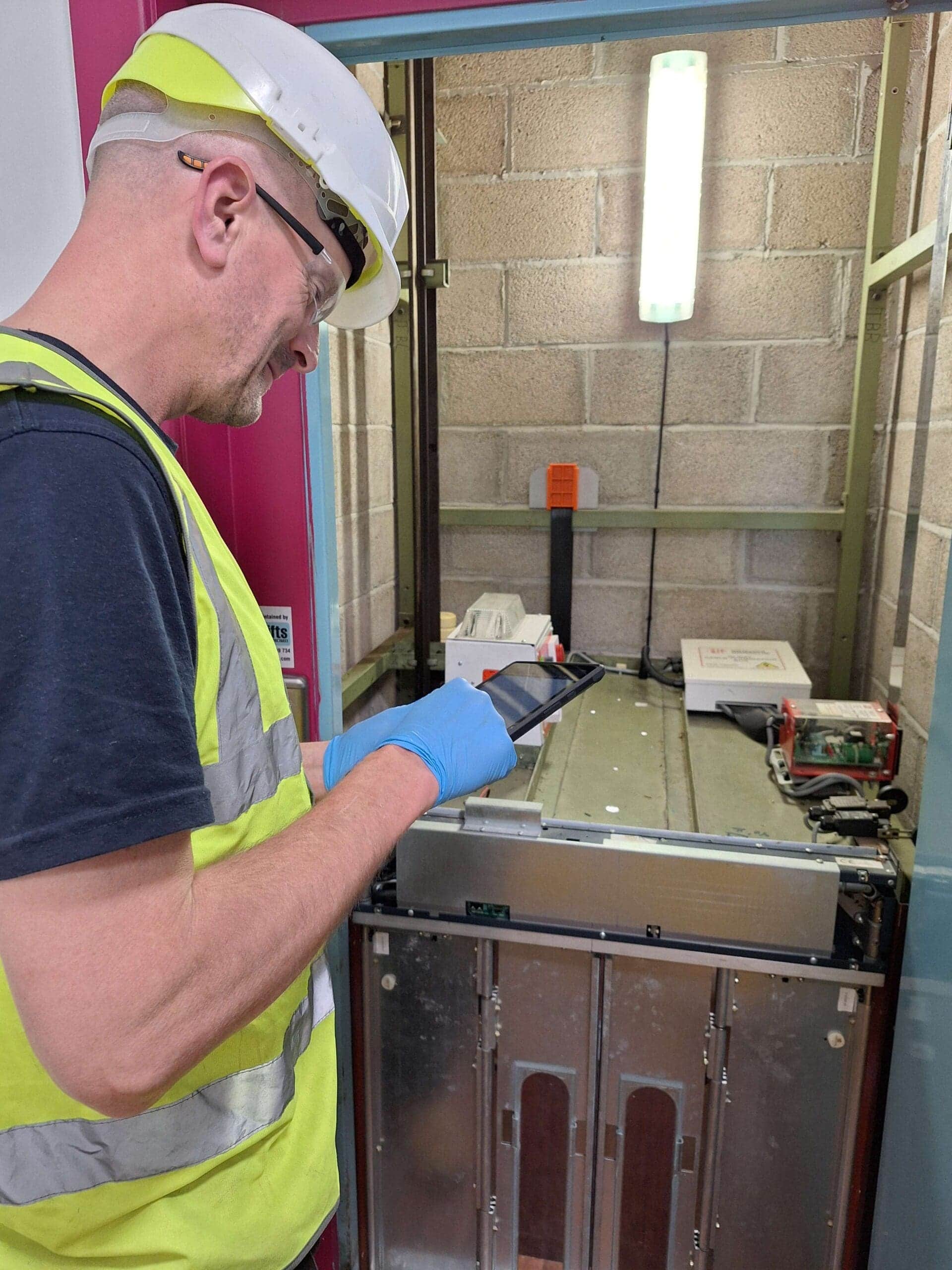 A man servicing a lift